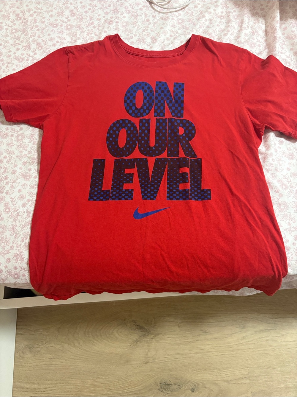 Nike Red Kids Tee with Blue 'ON OUR LEVEL' Graphic